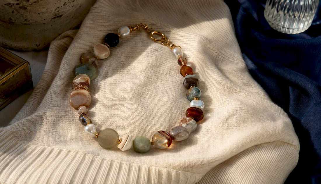 Layered beaded statement necklaces on white linen
