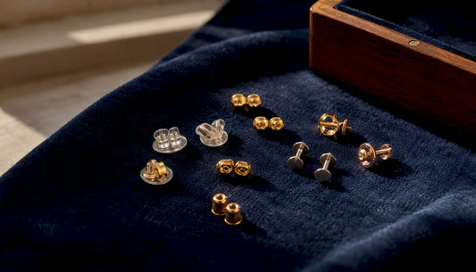 Close-up of mixed earring backs on fabric
