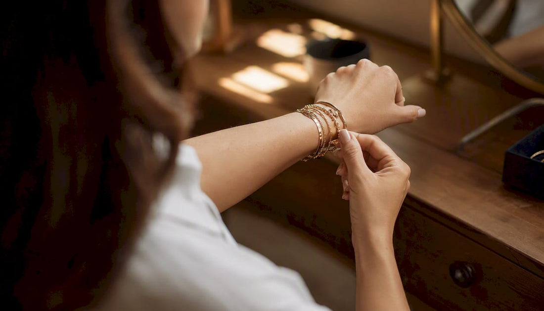 Wrist showcasing layered bracelet stack