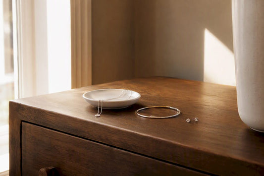 Curated minimalist jewelry pieces on cream fabric
