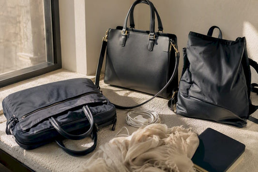 Three work handbag styles on a textured surface