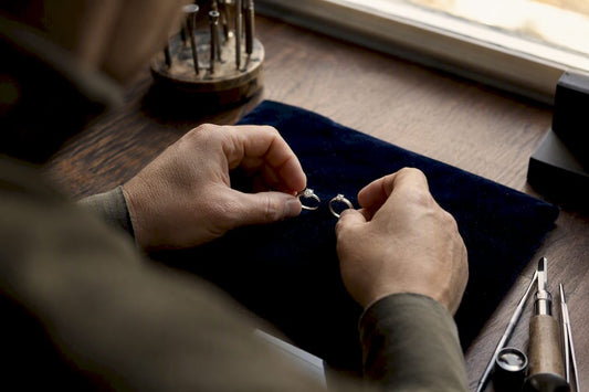 Close-up of hands holding platinum and white gold rings