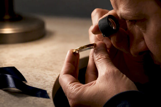 Jeweler examining refined metal jewelry details