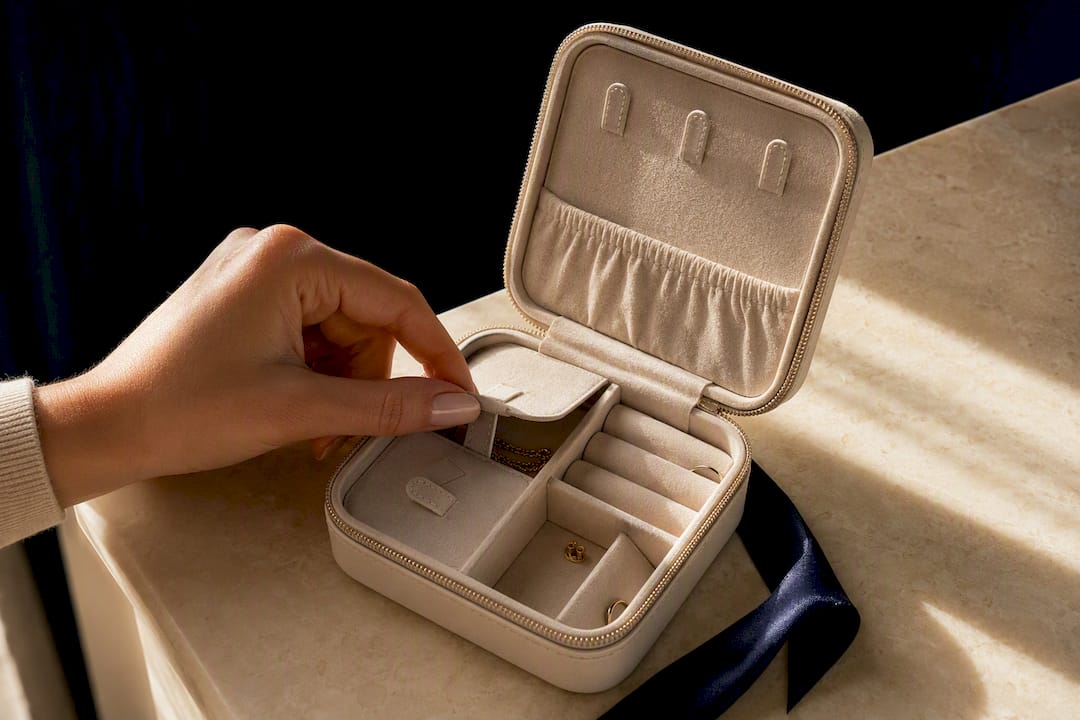 Open travel jewelry case with organized compartments