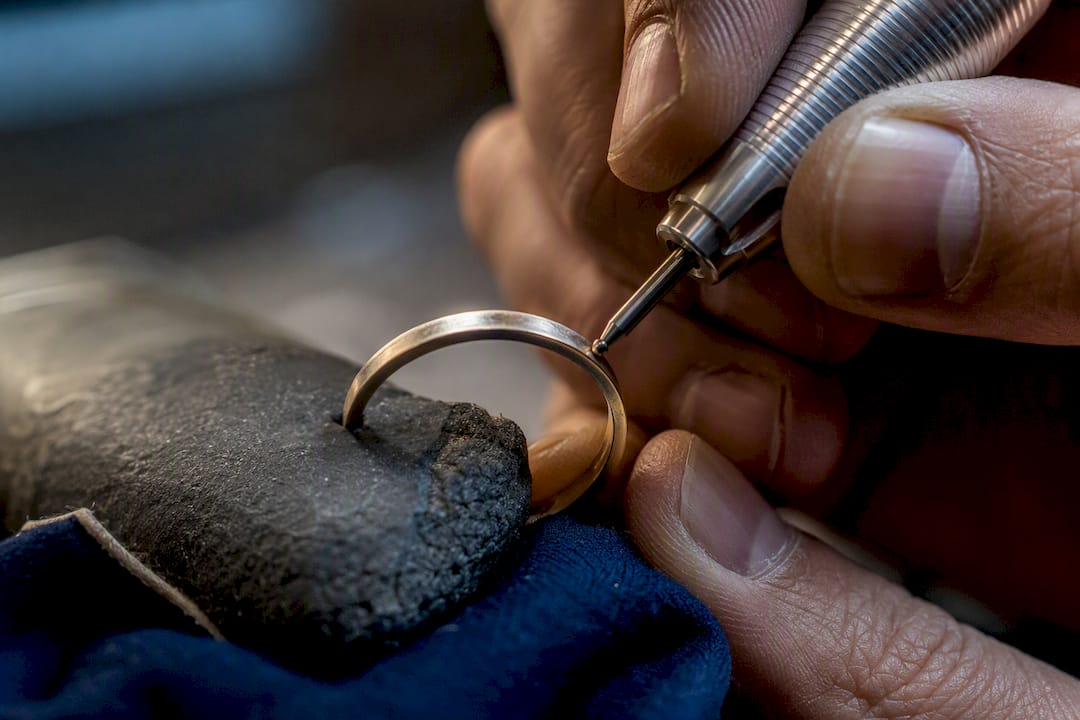 Artisan engraving a ring band close-up