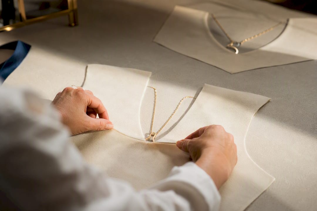 Stylist matching necklace shapes to necklines