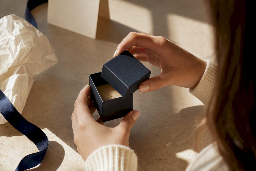 Daughter opening an elegant jewelry gift box