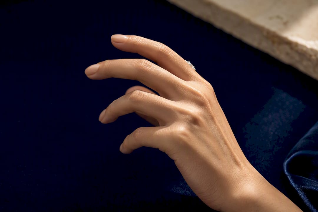 Petite hand showing elongated ring proportions
